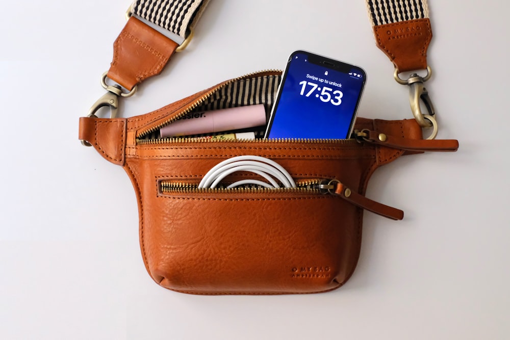 a brown purse with a blue tag