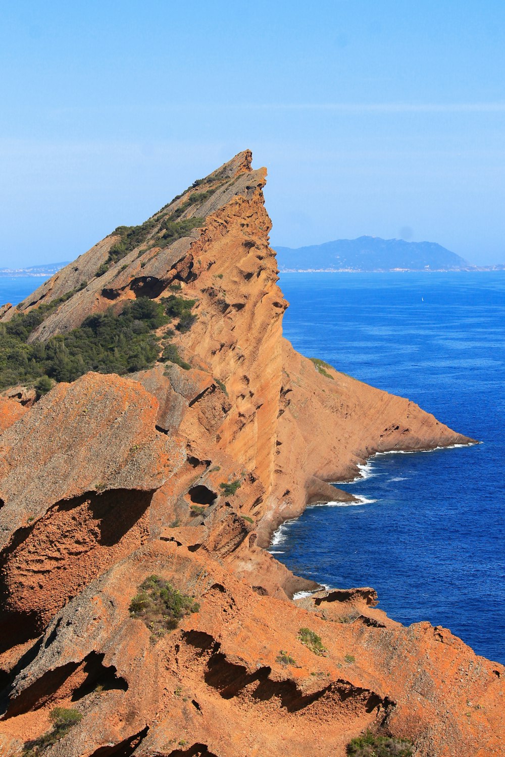 a cliff with a body of water below