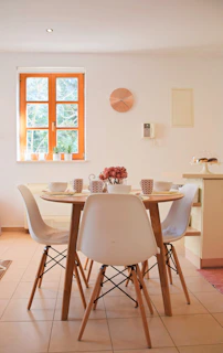 A cheerful dining area set for a home-cooked meal with fresh flowers on the table