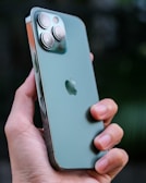 Close-up of hands holding a sleek smartphone with a vibrant screen display.