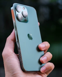 Close-up of hands holding a highly rated budget smartphone with customer rating stars visible.