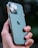 Close-up of a hand attaching a green phone grip to a smartphone