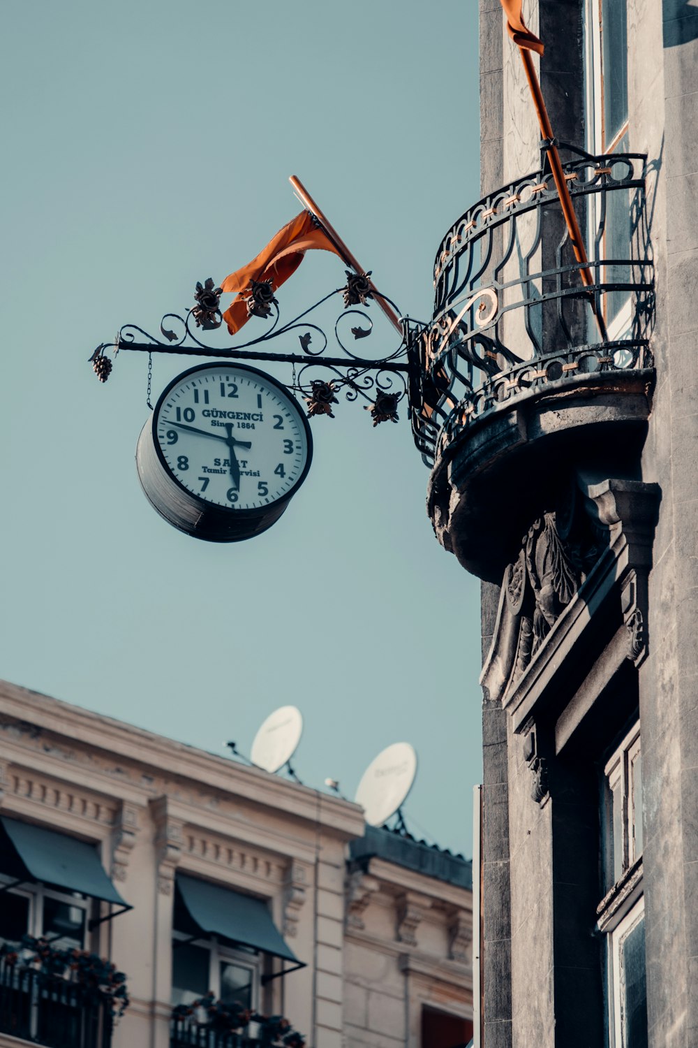 a clock tower with a satellite dish