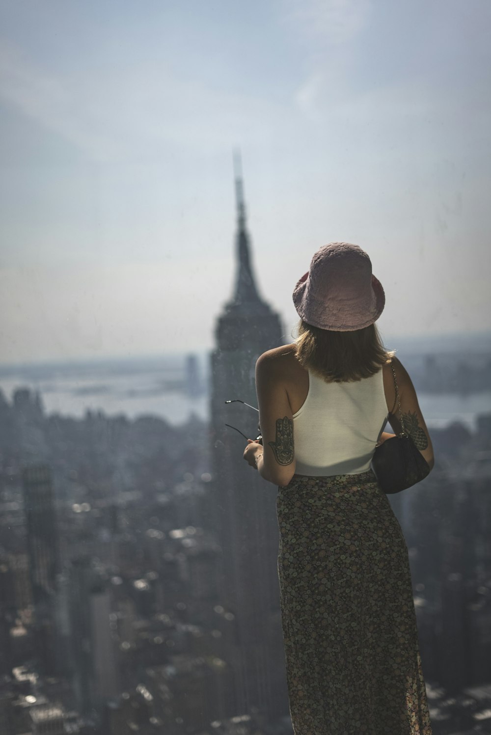 a person standing on a balcony overlooking a city