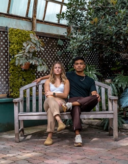 a man and a woman sitting on a bench