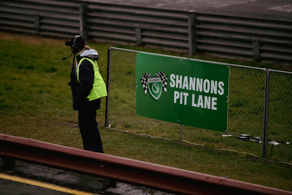 a person standing next to a sign