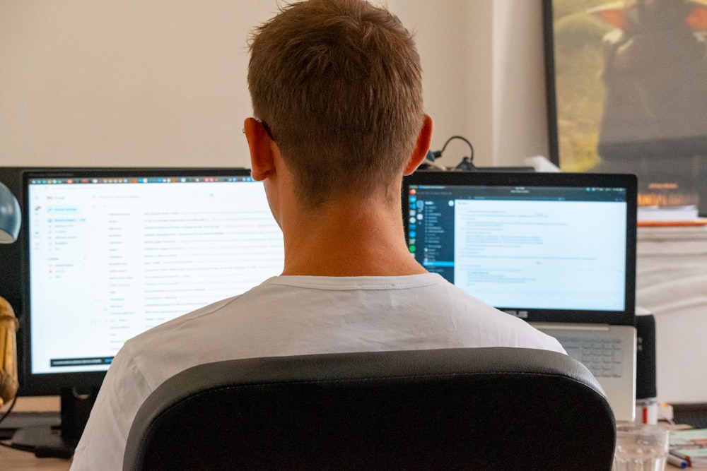 a man sitting in front of a computer