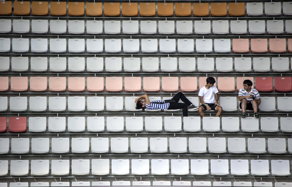 a group of men sitting on a bench