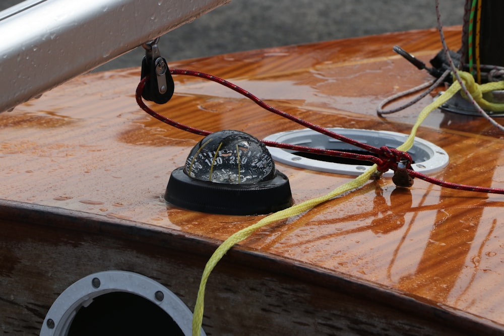 a black and red circular object with wires coming out of it