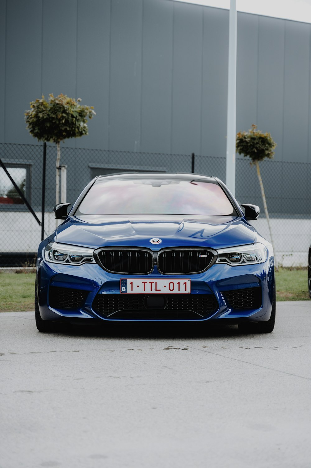 a blue car parked in front of a building