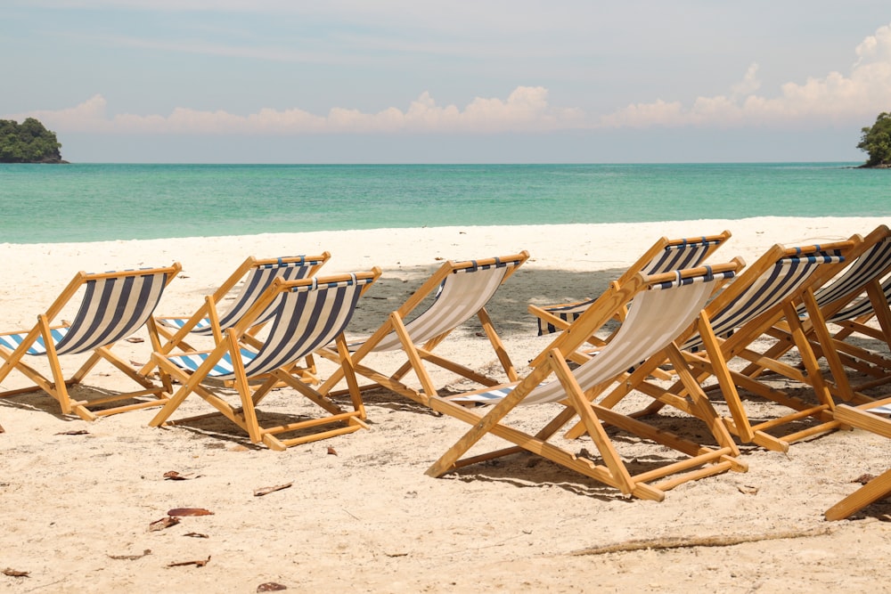 a row of chairs on a beach
