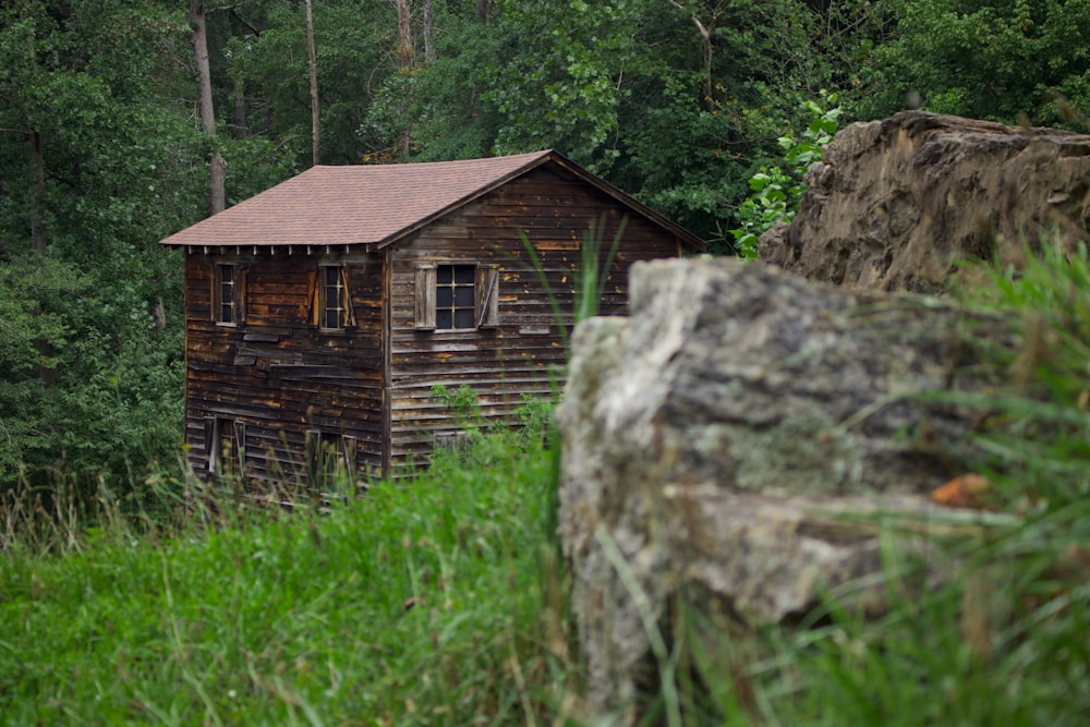 a wooden building on a rock