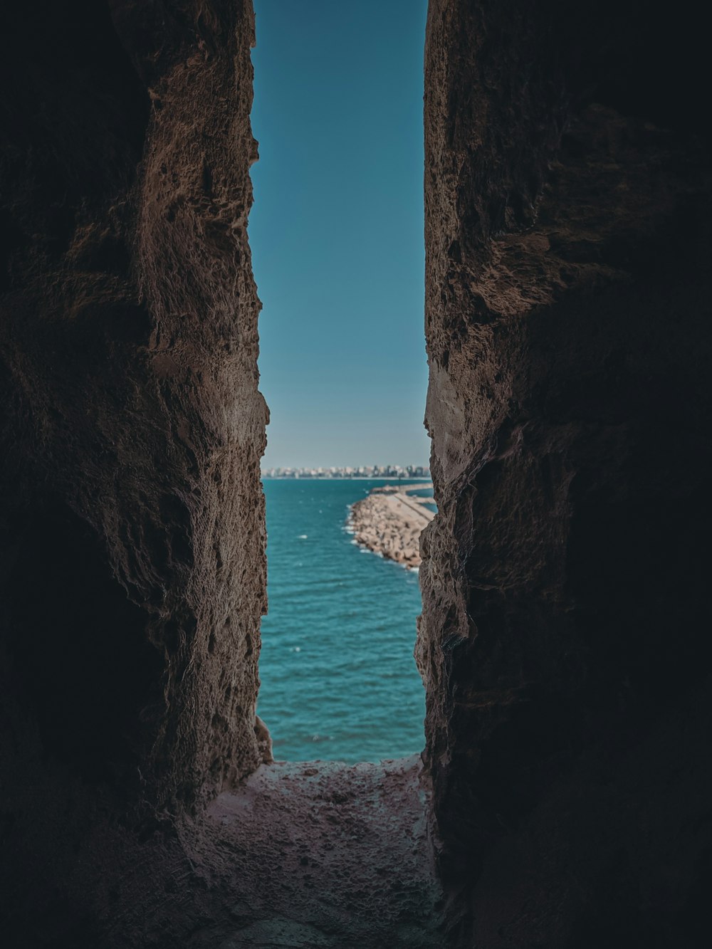 a view of the ocean through a cave