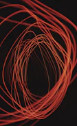 An interactive mouse cursor trail effect glowing softly in amber on a charcoal background.
