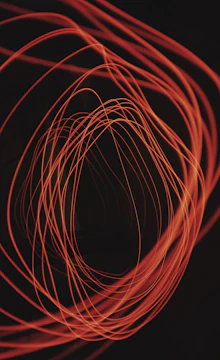 An interactive mouse cursor trail effect glowing softly in amber on a charcoal background.