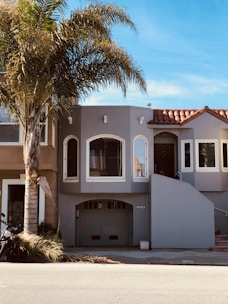 a white building with trees in front