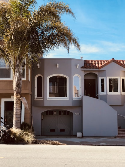 a white building with trees in front
