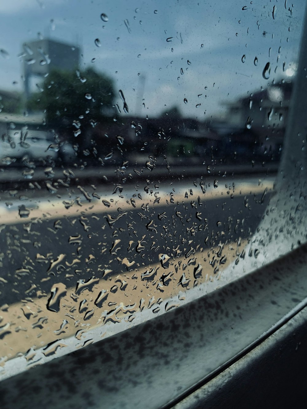 a window with a view of a city and a street