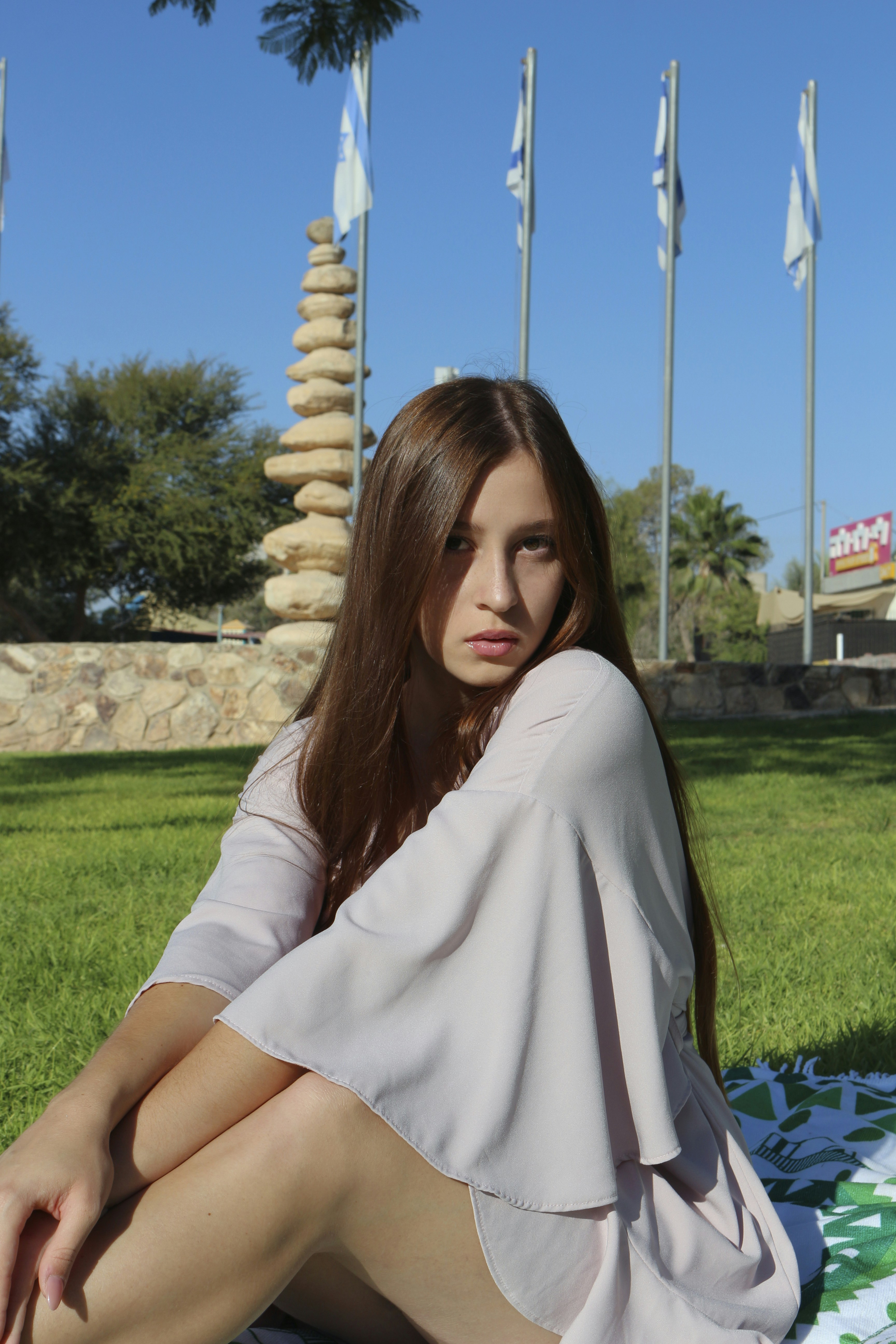 a woman sitting on a lawn