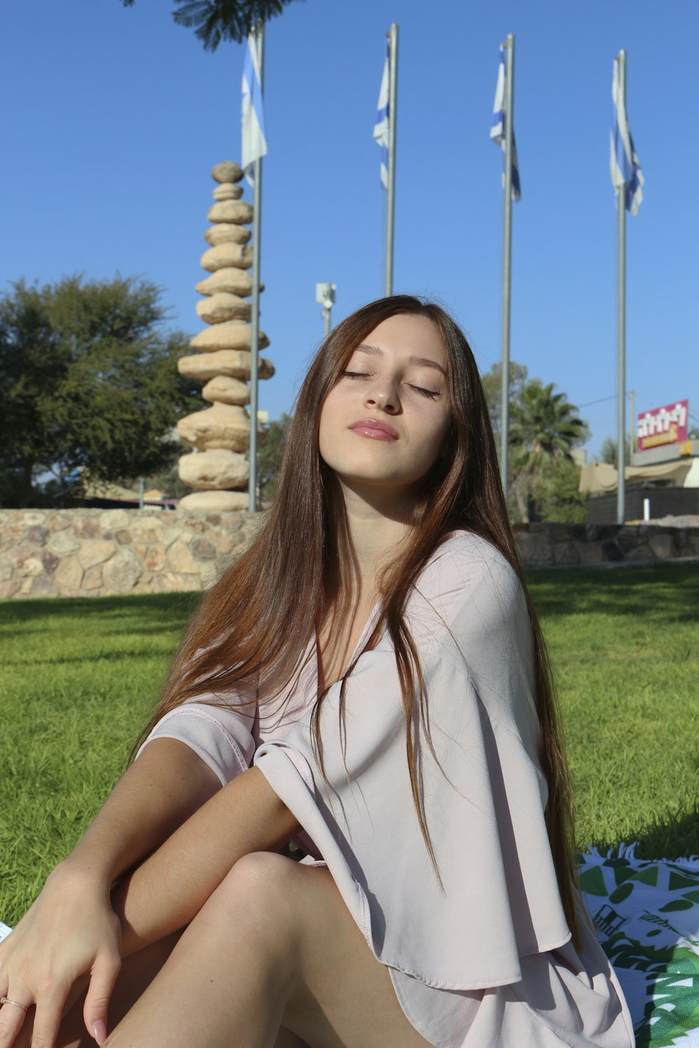 a woman sitting on grass