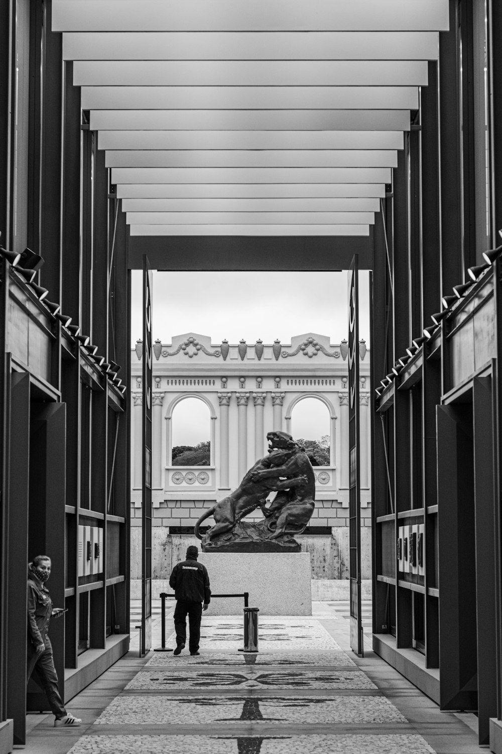 a statue of a person holding a gun in front of a building