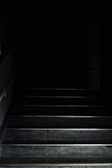 A dark, winding staircase descending into an unknown abyss.