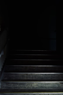 A long, narrow staircase leading into darkness.