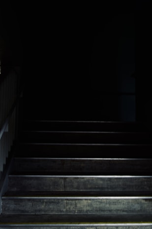 A long, narrow staircase leading into darkness.