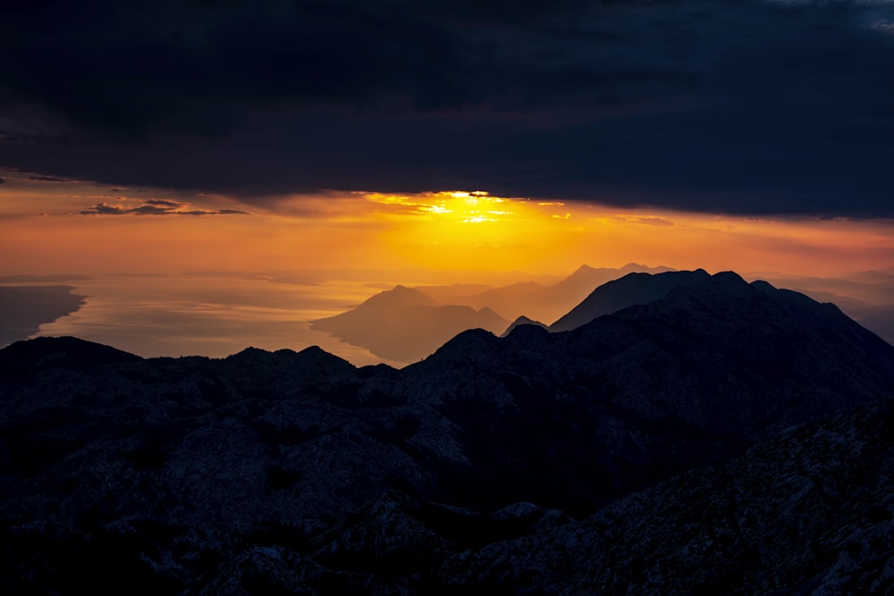 a sunset over a mountain range