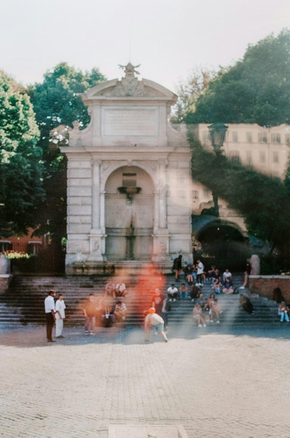 a group of people around a fountain