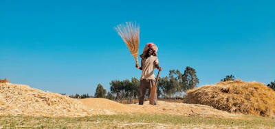 Close-up of hands holding farm tools, symbolizing rural retirement.