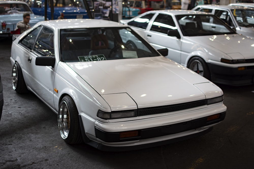 a white car parked in a showroom