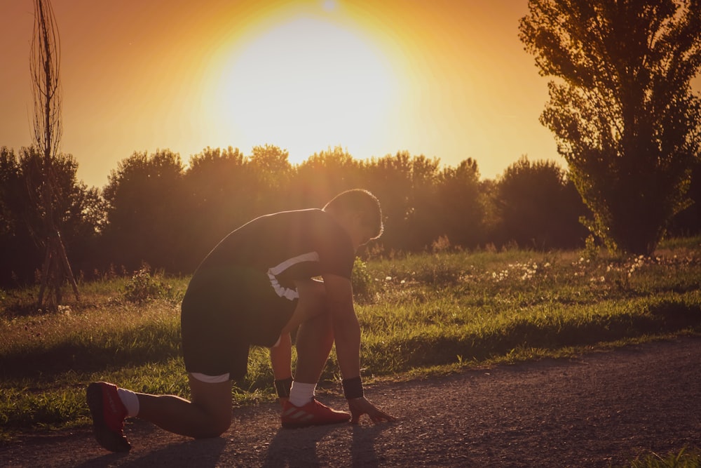 a man kneeling down and holding a frisbee