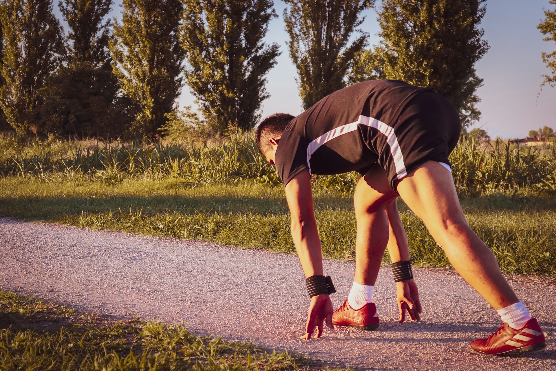 a person bending over on a road