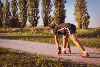 a man bending over on a road