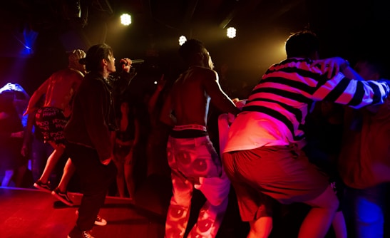 A vibrant concert featuring dancers and performers on stage.