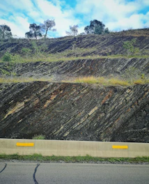 Steep Bali hillside with visible slope measurements and markers.
