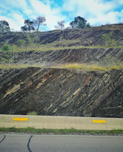 Steep Bali hillside with visible slope measurements and markers.