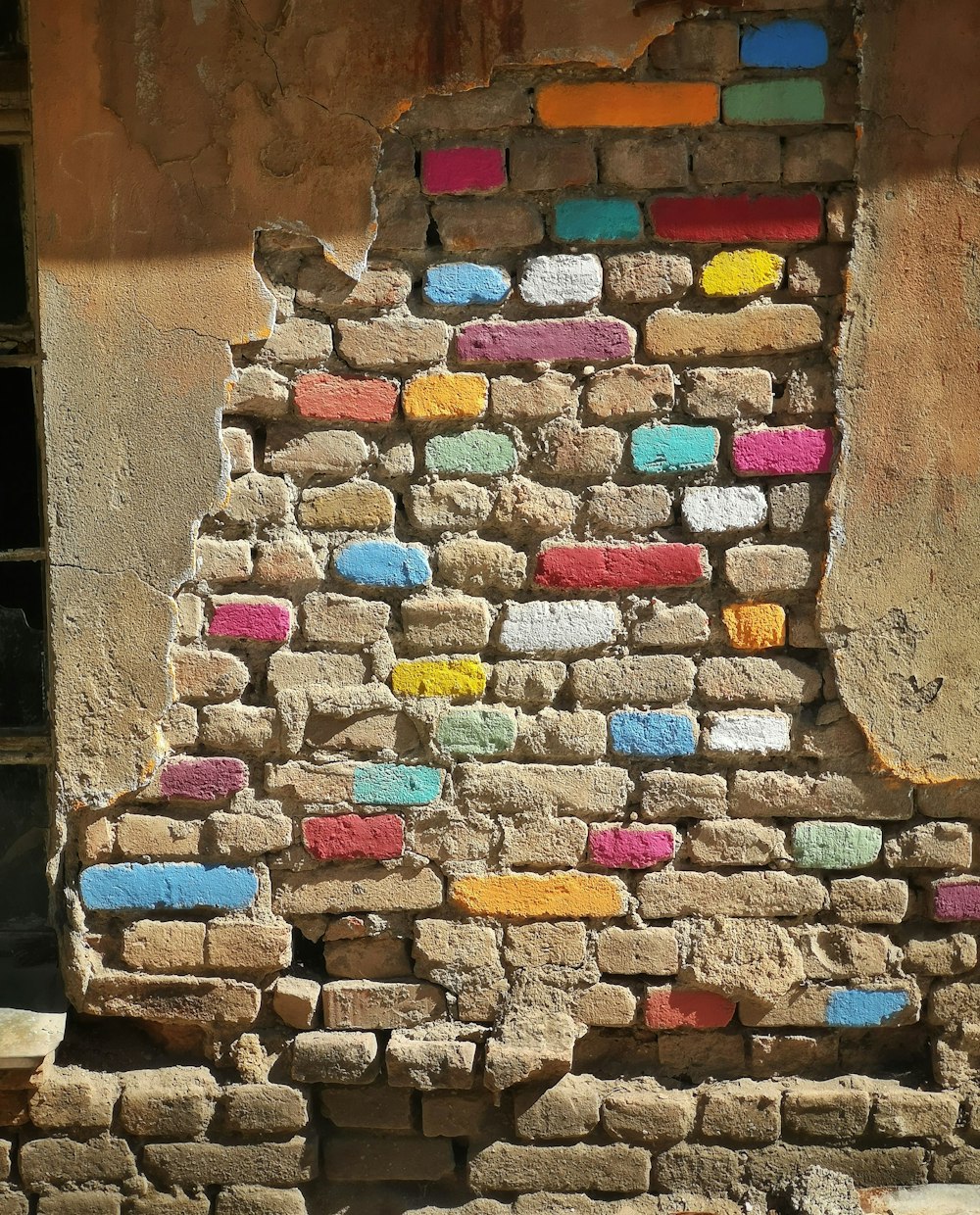 a brick wall with colorful tiles