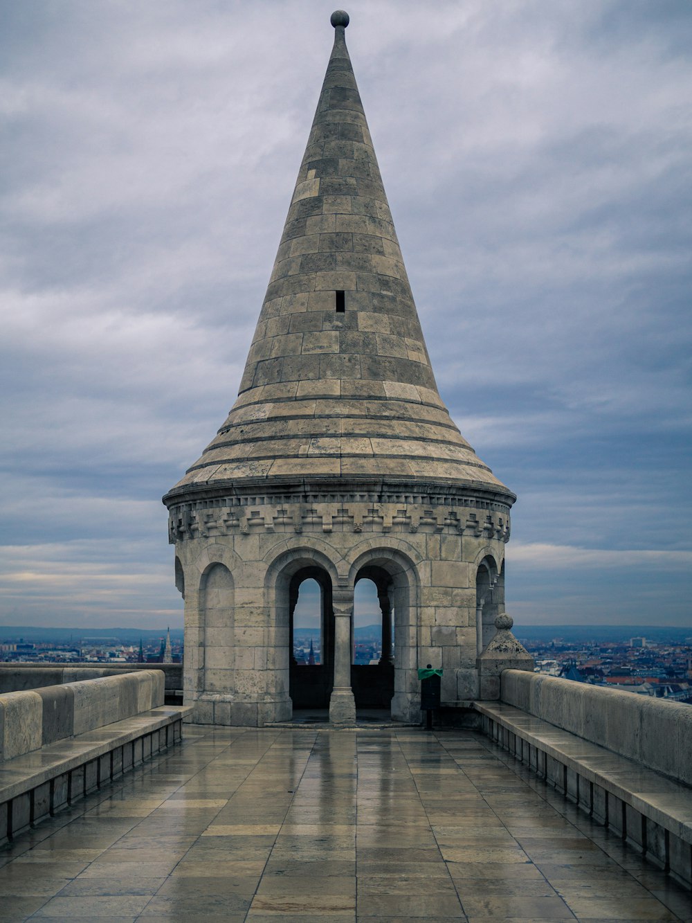 a stone tower with a walkway