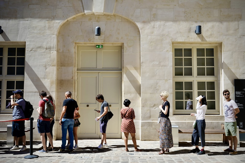 a group of people standing outside a building