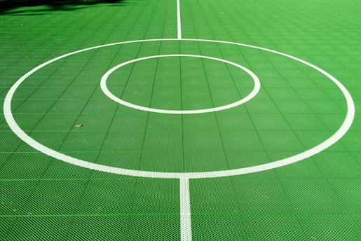 A freshly installed epoxy tennis court with vibrant colors and smooth finish