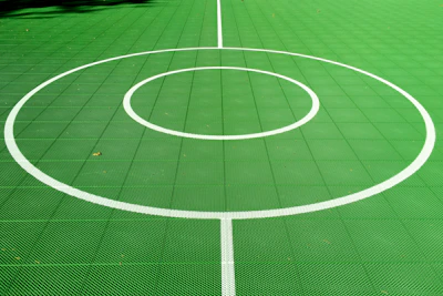 Players exchanging high-fives in front of the vibrant forest green court lines.