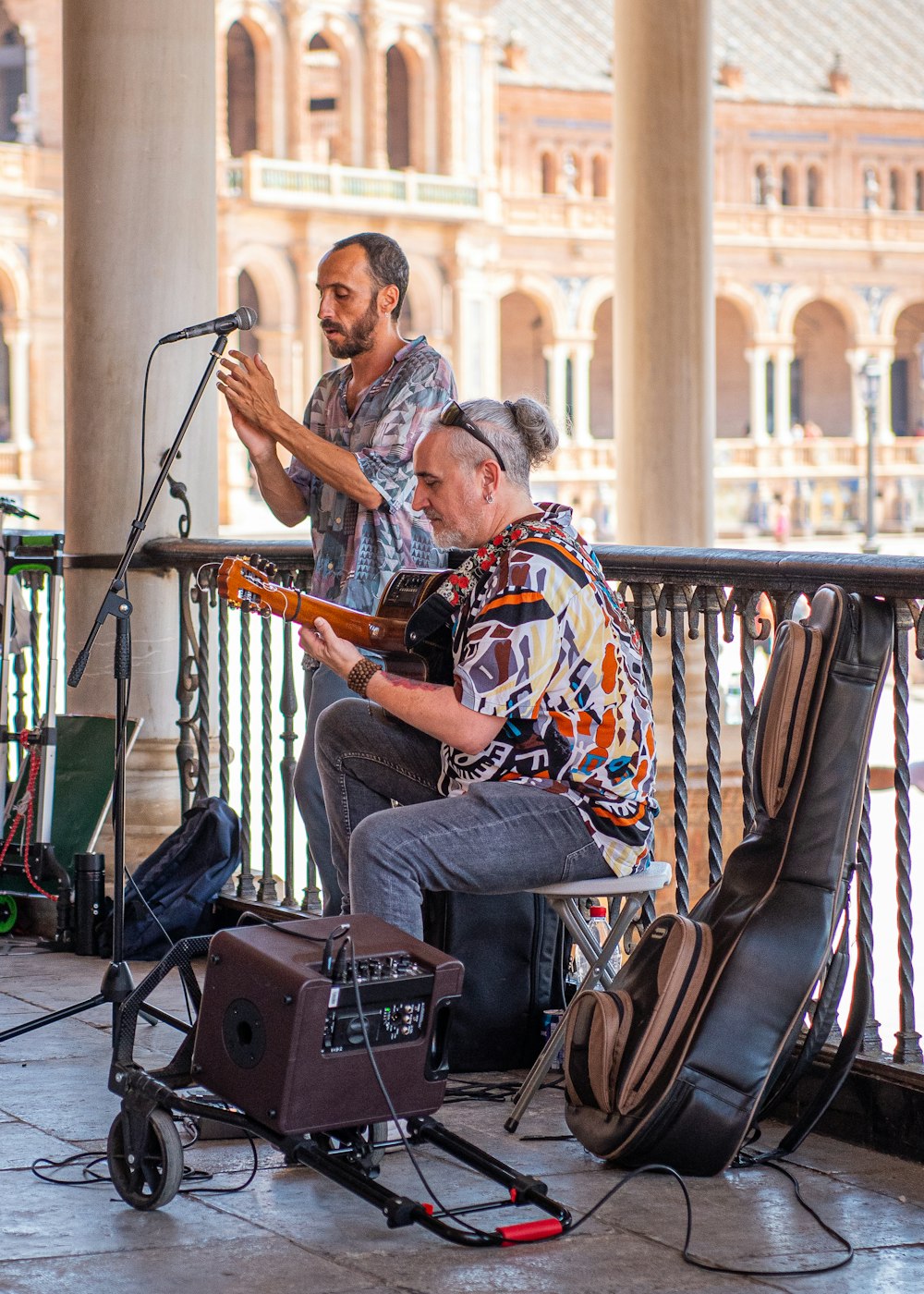 a couple of men playing guitars