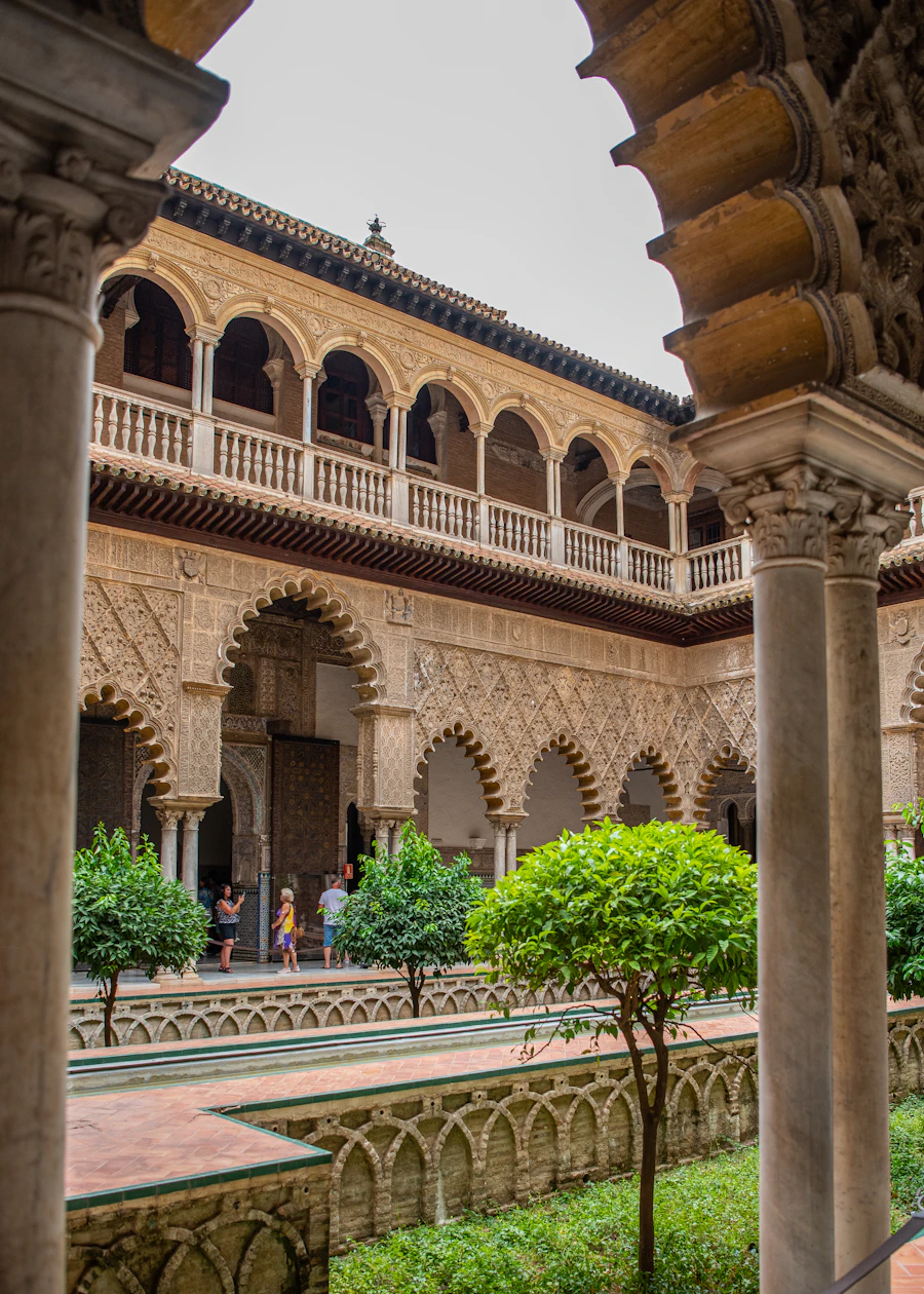 Real Alcázar Seville ornate tiled courtyard with arches and gardens