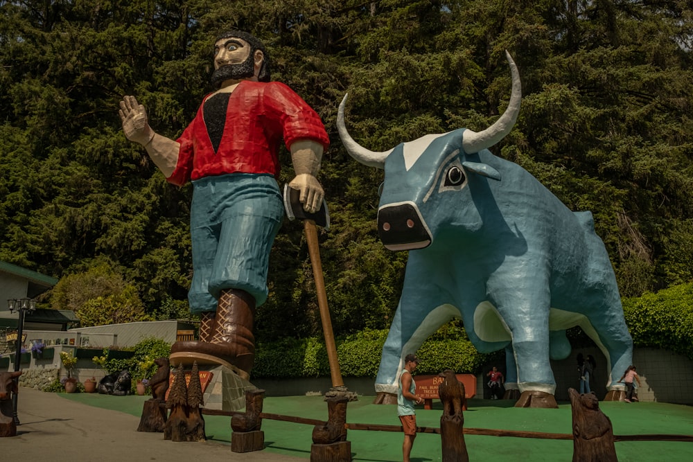 a man standing on a statue of a bull