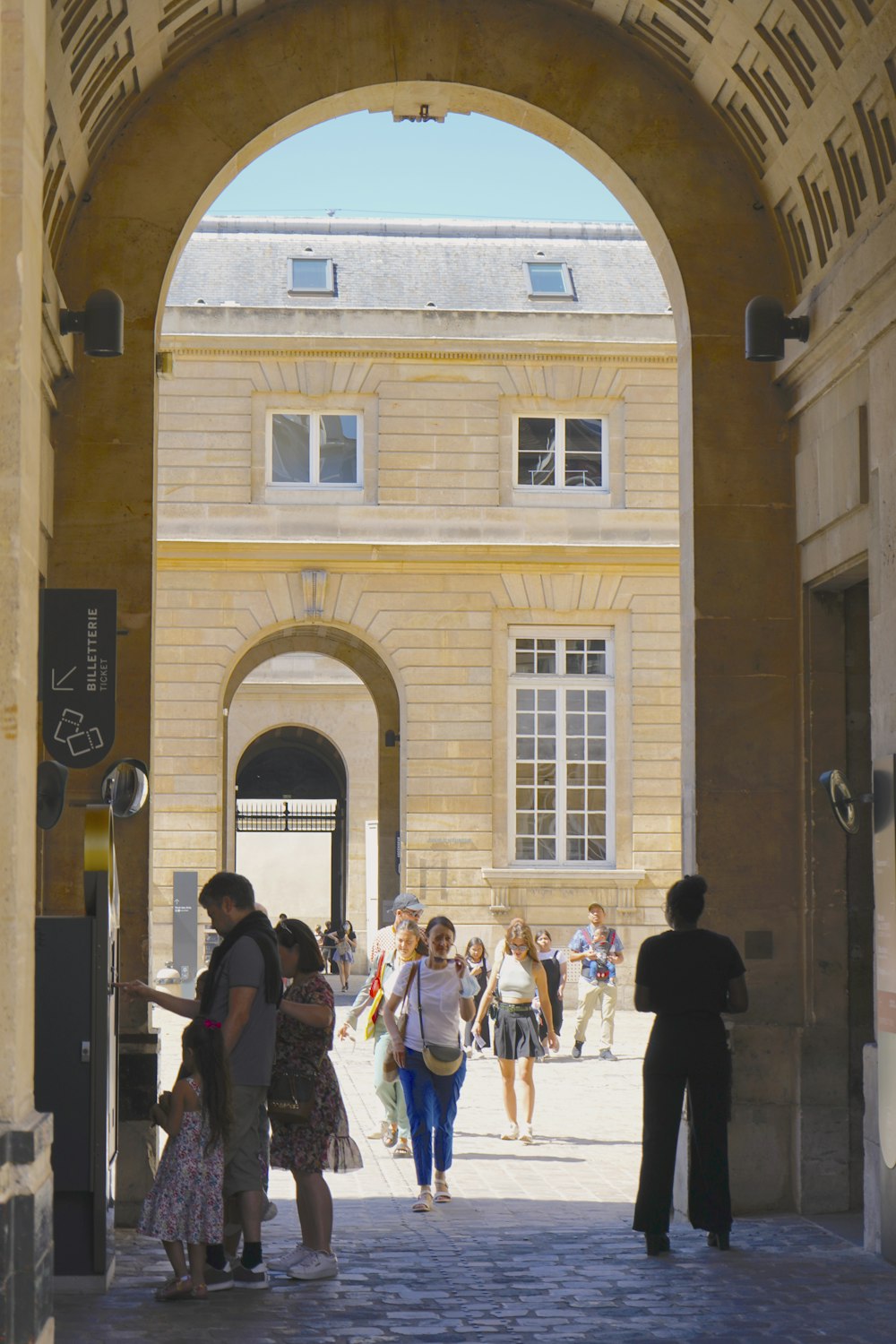 a group of people walking through a building