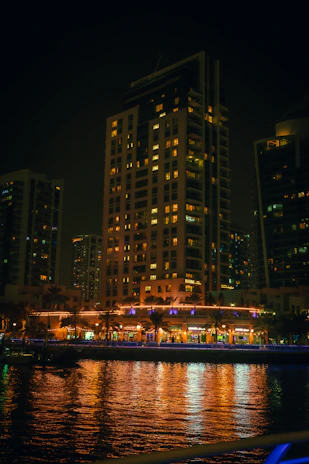 Evening lights glowing warmly from a lamaj mixed-use development in Jeddah.