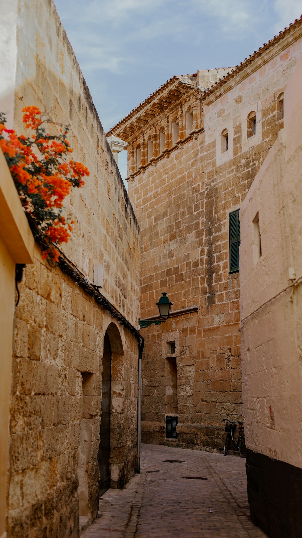 a stone street between two buildings