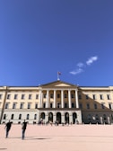 A panoramic view of the Peruvian Congress building under a bright blue sky.